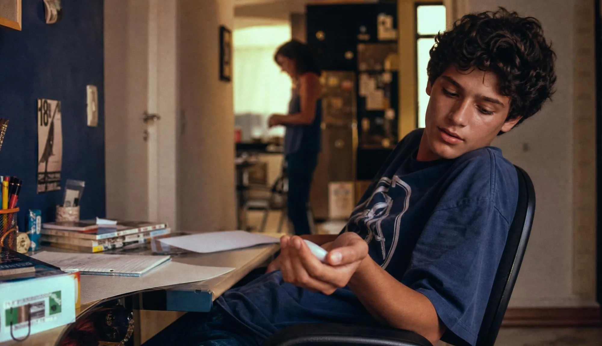 Young person using the device beside a study desk.