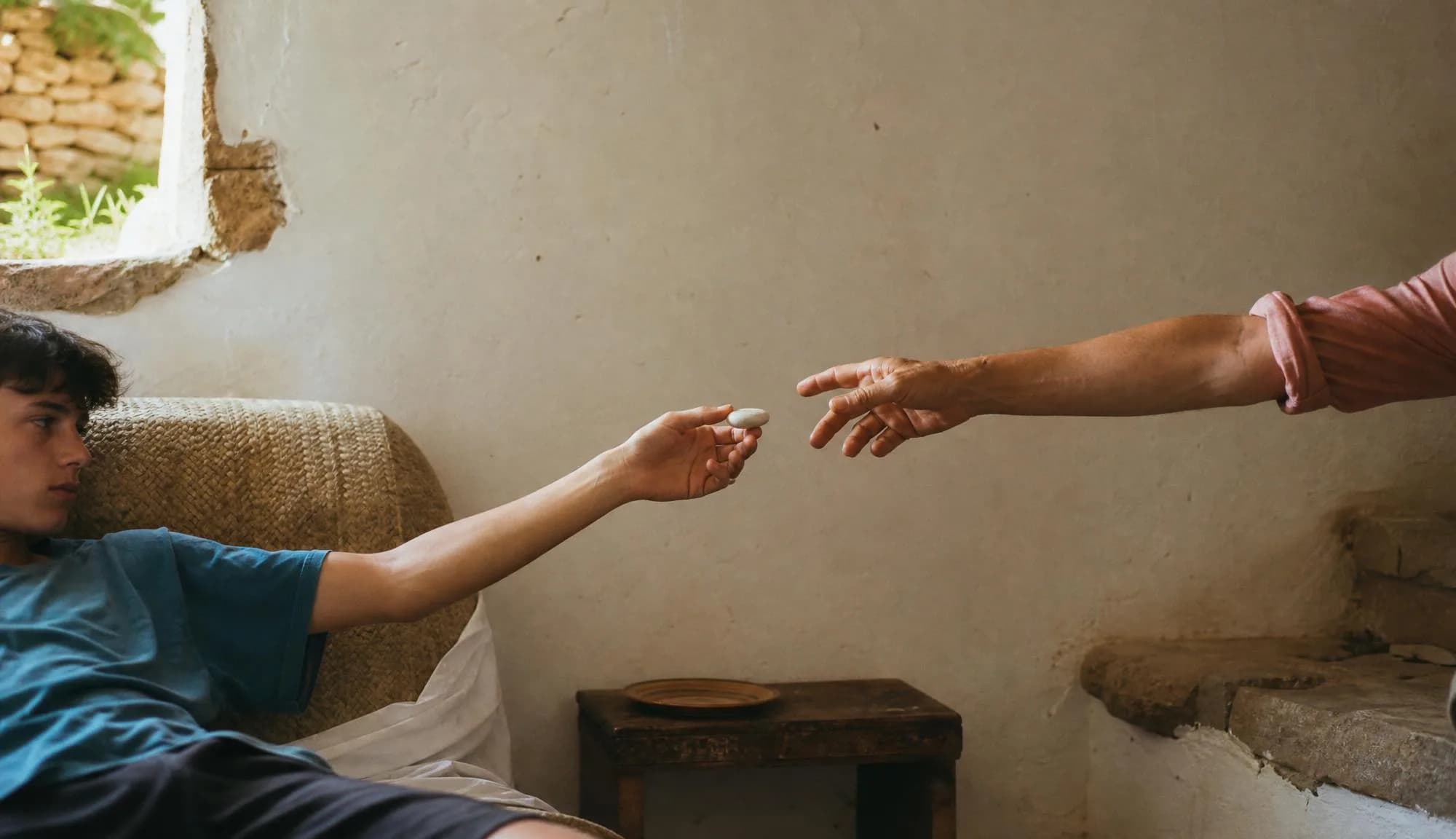 Outstretched hands passing the device.